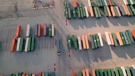 yard jockey truck driving with container in a intermodal terminal rail road with yard full of containers