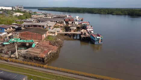 aerial flying down from ships to bridge in buenaventura, colombia