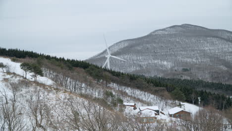 spinning wind turbine on winter wonderland at daegwallyeong sheep farm in pyeongchang county, south korea