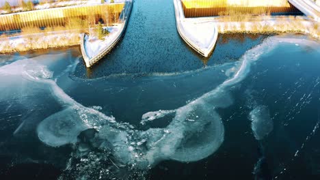 veluwemeer aqueduct in harderwijk, netherlands, aerial drone flying above frozen lake, dolly in