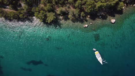 Birdseye-view-of-a-private-beach-where-a-vessel-is-anchored,-Brac-Island,-Croatia-during-summer-time