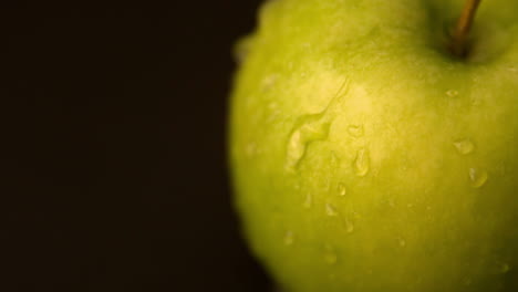 water rolling off green apple