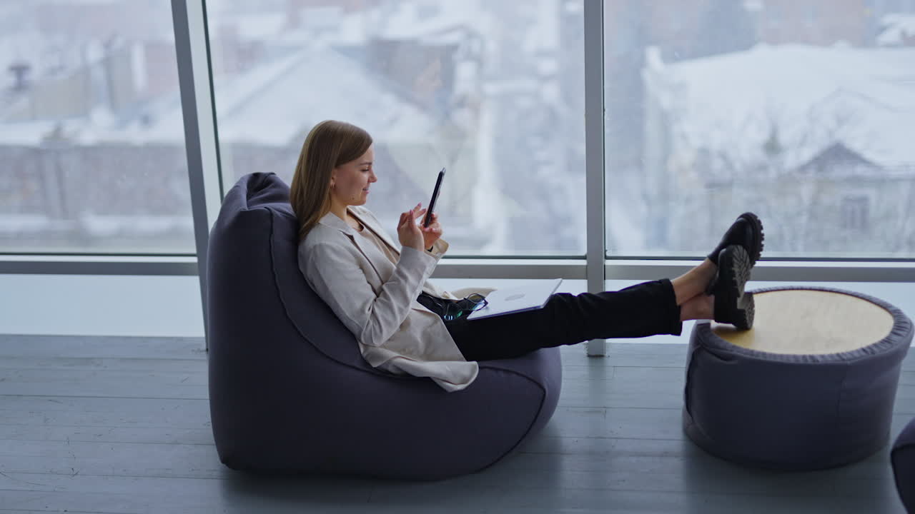 Woman working in a cozy office space on a snowy day