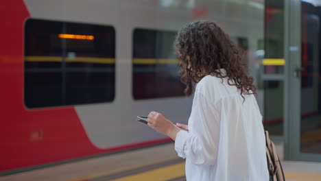 woman waiting for train at station