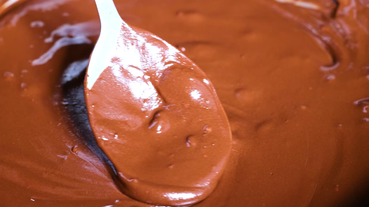 Spoon stirring melted chocolate chips smoothly