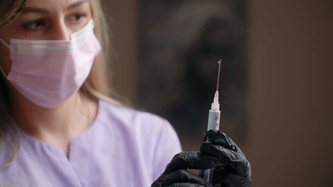 Nurse holding a syringe