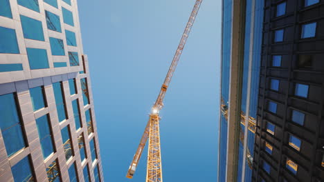 A-Huge-Construcción-Crane-Near-Office-Buildings-With-Glass-Facades-City-Building-Steadicam-Shot