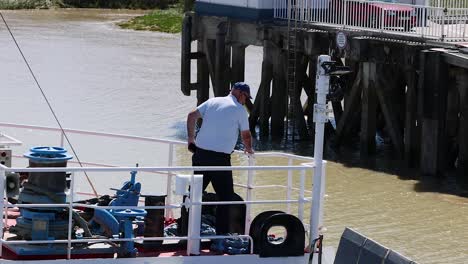 man docking boat at blaye pier