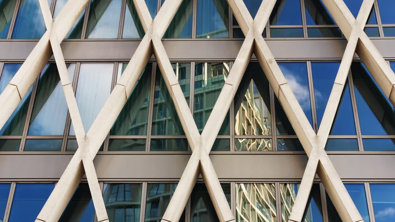 White clouds moving in reflection of geometric facade windows in modern timelapse composition