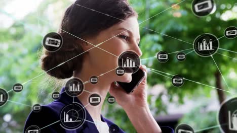 animation of icons connecting with lines over young caucasian businesswoman talking on phone