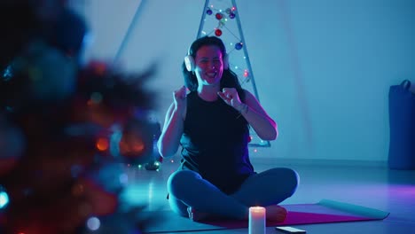 woman meditating and dancing to music during christmas season