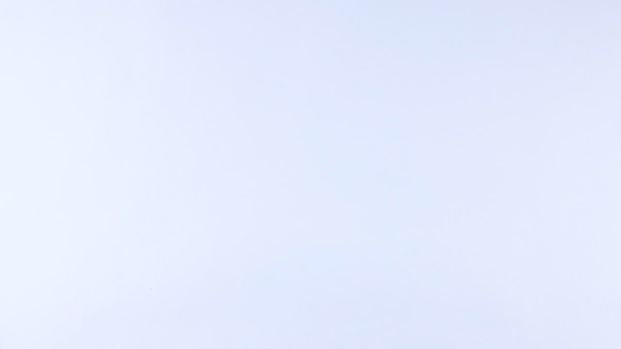 A tennis ball rolls across a white background