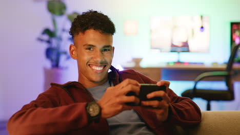 a young confident gamer playing on mobile looking