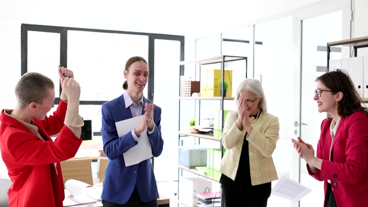 A group of colleagues celebrating a success in the office