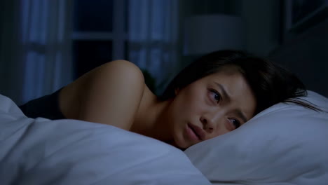 woman suffering from insomnia in bed at night