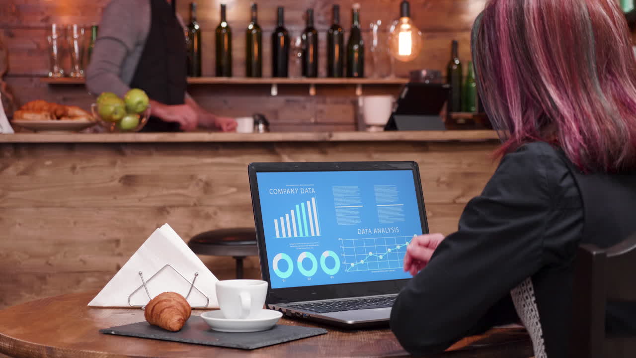 Woman working on data analysis in cafe
