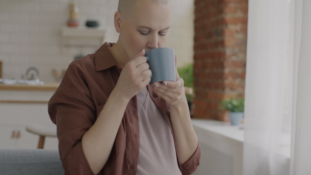 Pregnant Woman with Bald Head Drinking Coffee/Tea