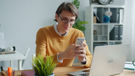 man using smartphone at work from home