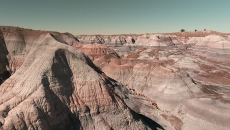 Aerial-reverse-dolly-through-colorful-hills-of-Petrified-Forest-National-Park