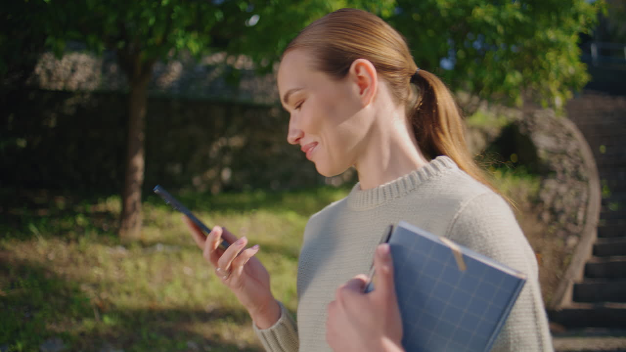 Smiling model calling street sunlight park closeup. Happy woman speaking phone