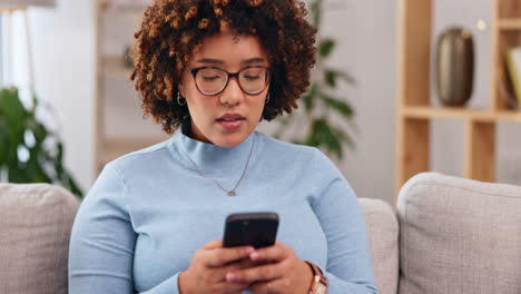 Serious,-phone-and-relax-with-woman-on-sofa