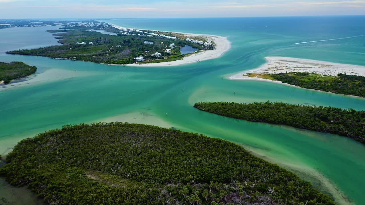 Tidal channels curve through teal shallows at Stump Pass, bordered by mangrove islands and pale sandbars that frame the passage between Manasota Key and Thornton Key on Florida’s Gu