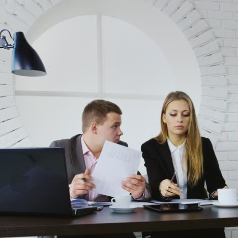 young colleagues in business meeting with tablet