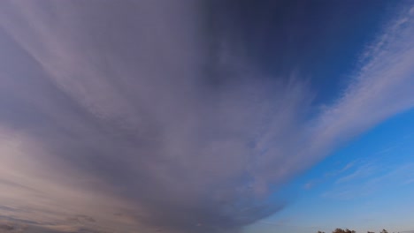 day - night time-lapse: clouds drift through sky as day turns to night