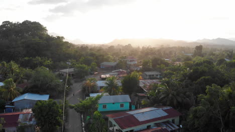 a drone shot of the late afternoon sun shining over a small central american village