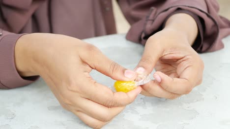 woman unwrapping a yellow candy