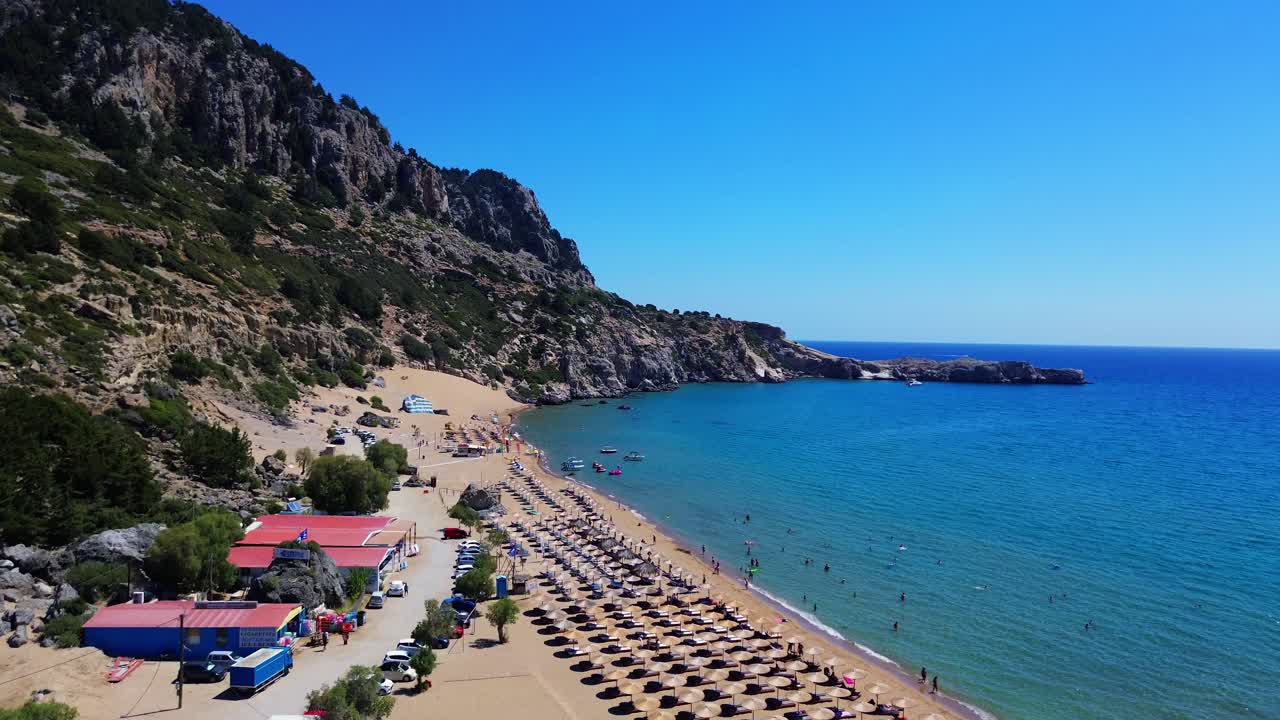 Tsambika beach in Faliraki, Rhodes in Greece filmed with the drone from above with Mediterranean Sea in the summer holiday