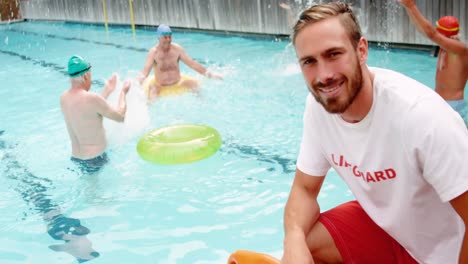 swim coach standing with whistle and inflatable floater