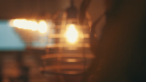 lights above dining table in a restaurant looking cozy while the focus shifts