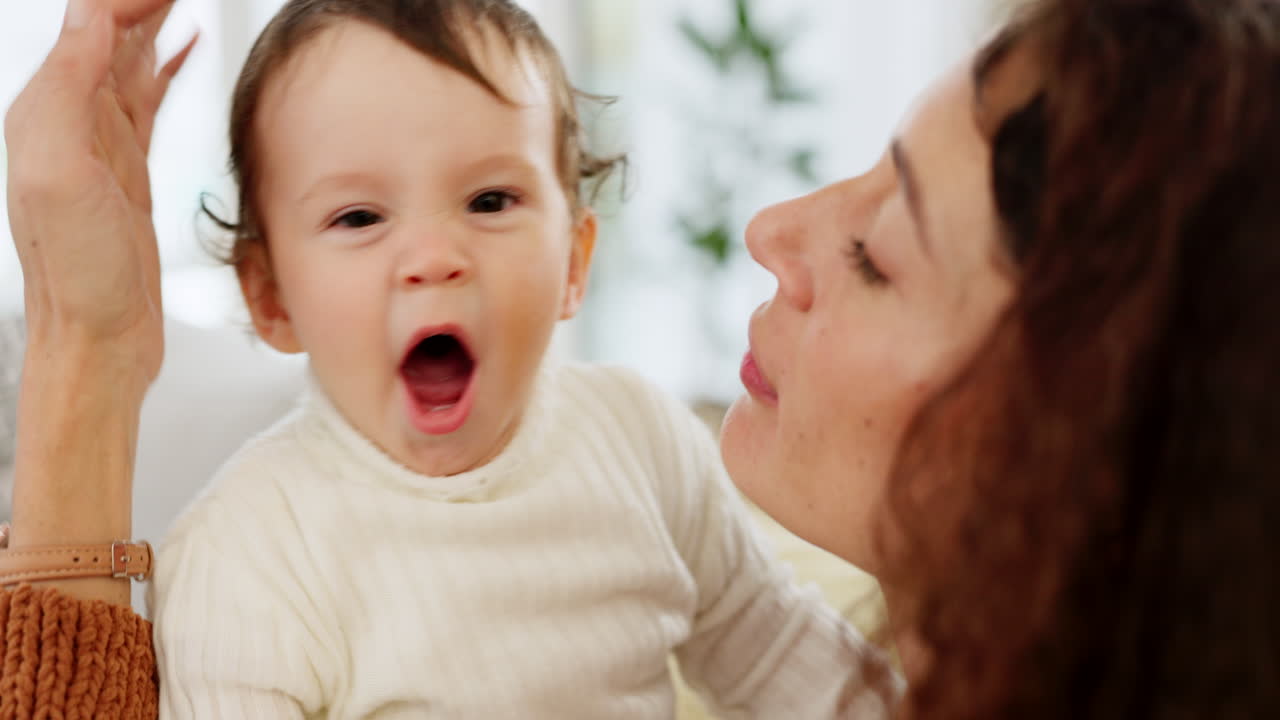 Tired, baby and mother yawning on sofa before
