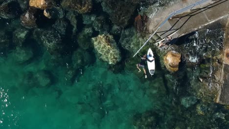 Two-surfers-using-stairs-to-leave-the-water