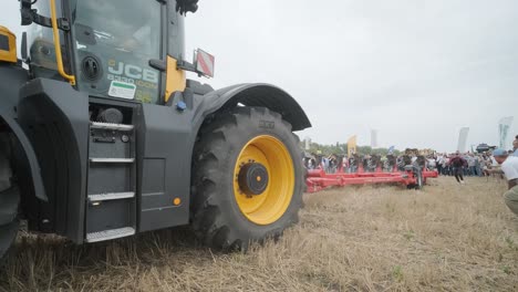 demonstration of agricultural machinery at an exhibition. tractors operate in the field, showcasing their capabilities and performance in action