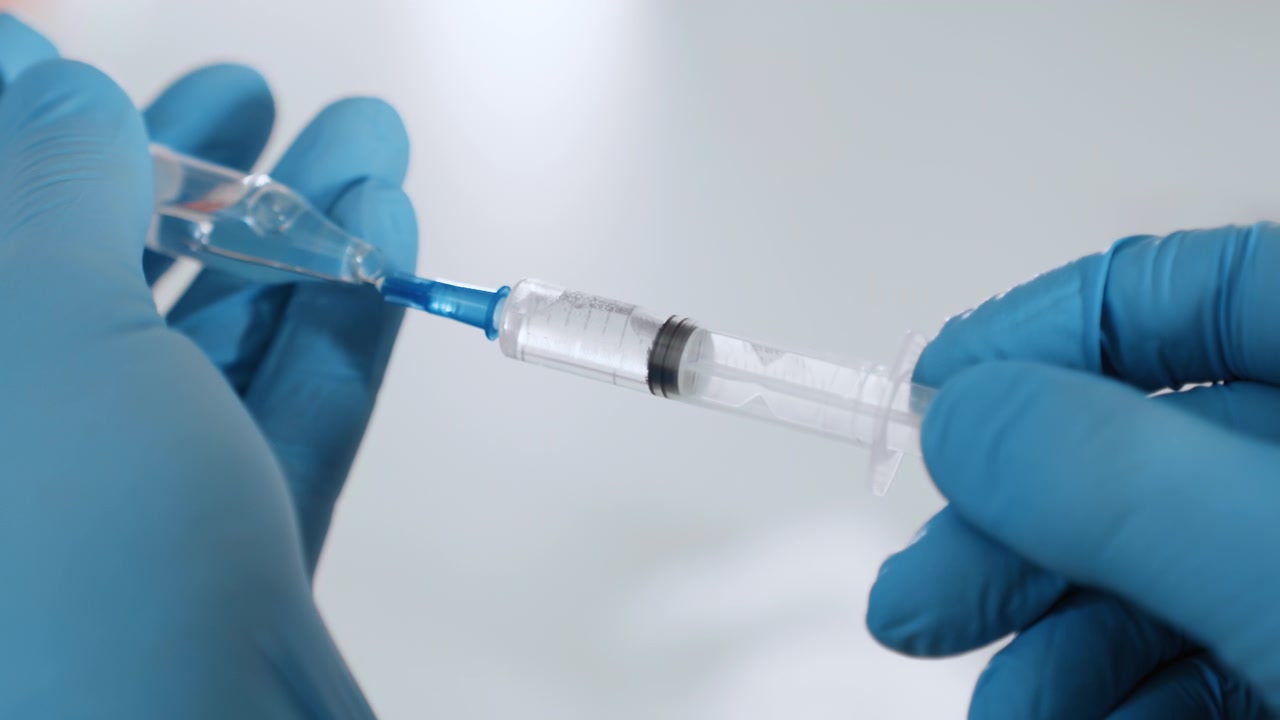 Hospital physician meticulously assembles syringe and accessories. Medical professional in hospital employs precise sterile methods to prepare syringe and equipment for medication administration