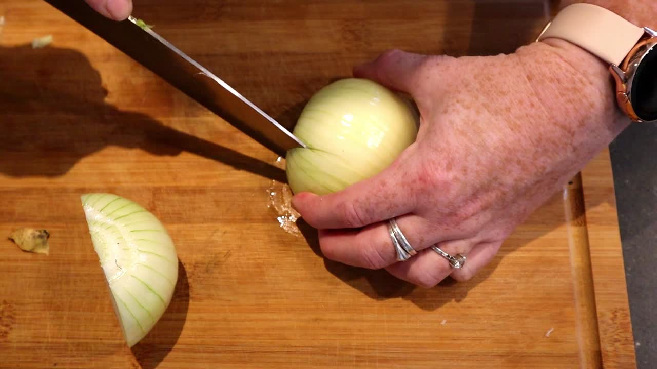 Cutting onion on a wooden board