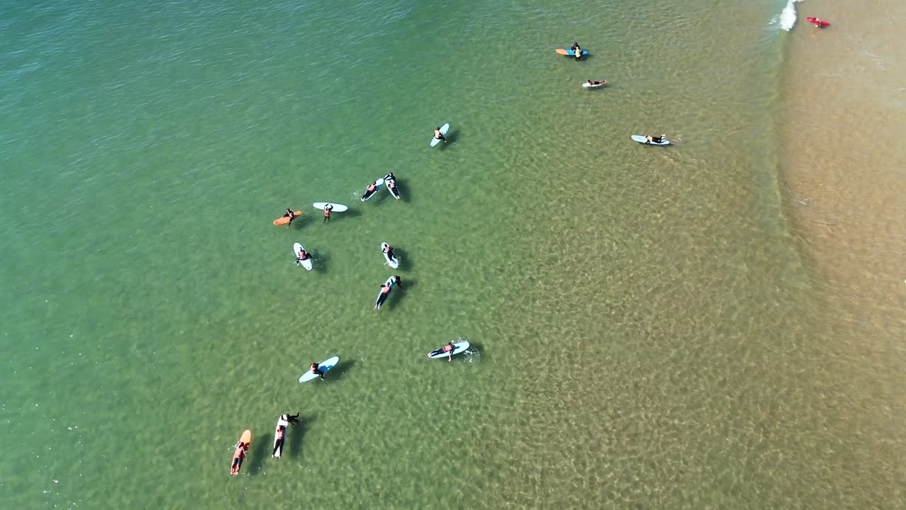 Aerial View of Surfers in the Ocean