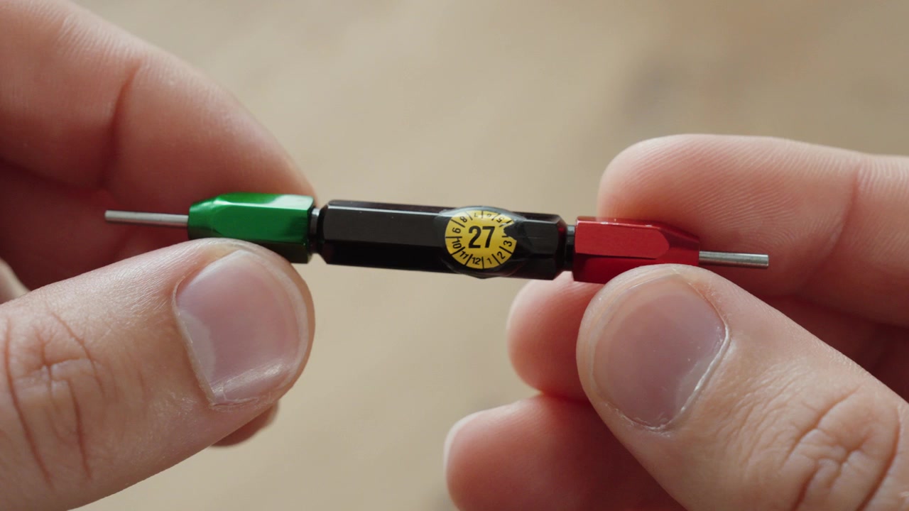 Close-up of a precision measuring tool displaying a calibration label, emphasizing measurement accuracy, quality control, and calibration compliance in industrial environments.
