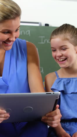 teacher teaching kids on digital tablet