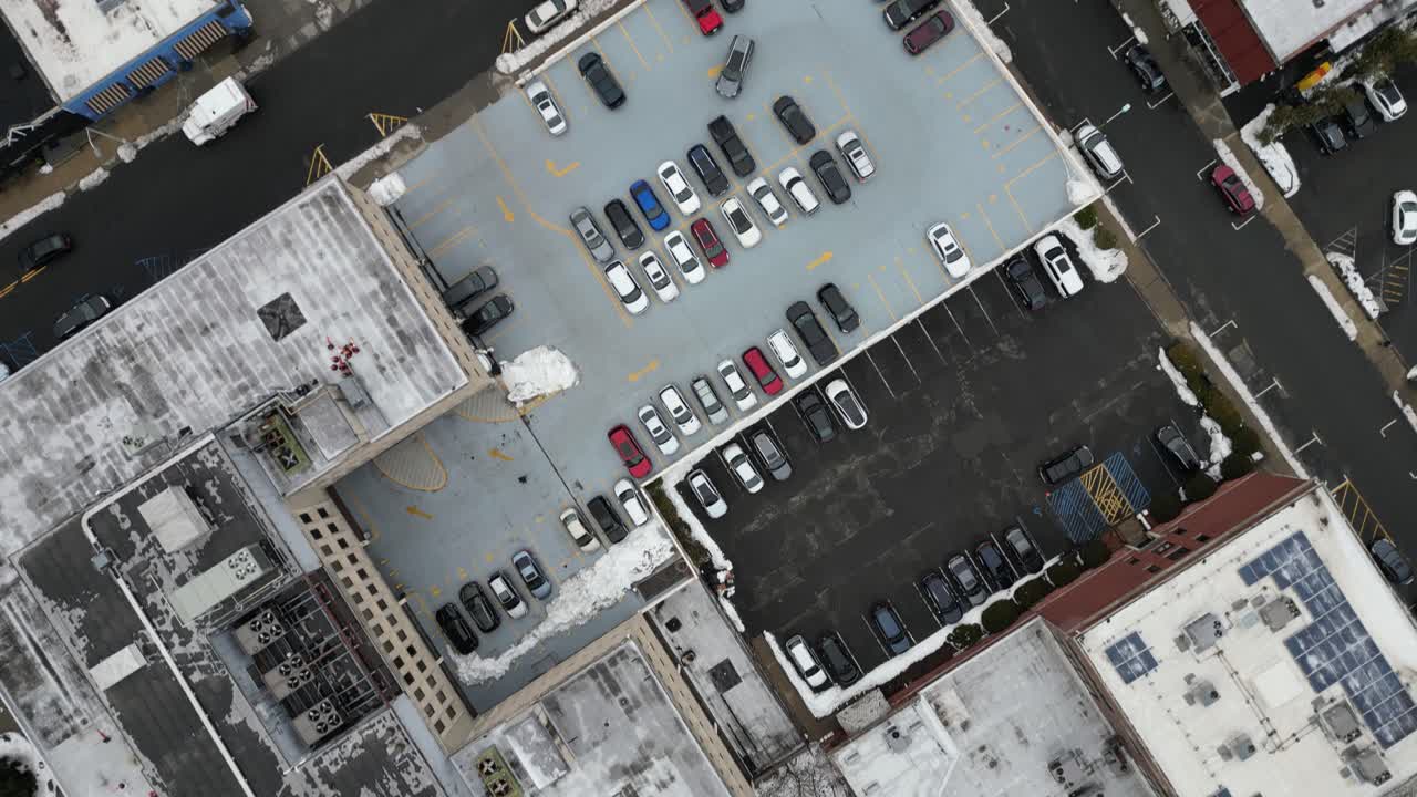 Aerial drone footage of South Jersey in winter, featuring snow-covered rooftops, streets, and urban areas. Capturing the cold season’s atmospher