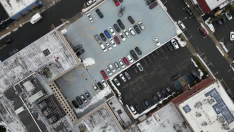 aerial drone footage of south jersey in winter, featuring snow-covered rooftops, streets, and urban areas. capturing the cold season’s atmospher
