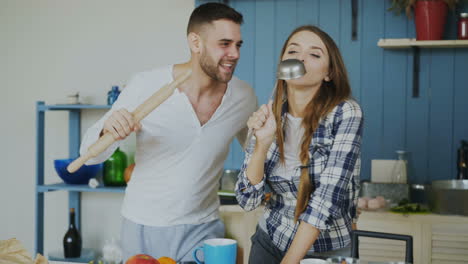 couple singing in kitchen