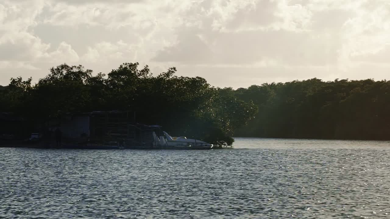 Gramame river during high tide with water moving quickly surrounded by exotic green foliage perfect for locals to bath and relax near the capital city of Joao Pessoa in Paraiba, Brazil