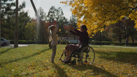 woman with paralysis has fun playing with daughter in park