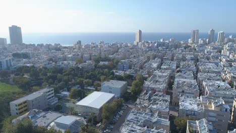 aerial view of the coastal town of bat yam on the shores of the mediterranean sea as panorama skyline and urban seascape, israel. top view of residential city view middle east buildings and streets shot houses at the horizon.