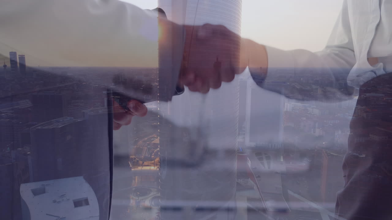 Animation of caucasian businesspeople shaking hands over cityscape