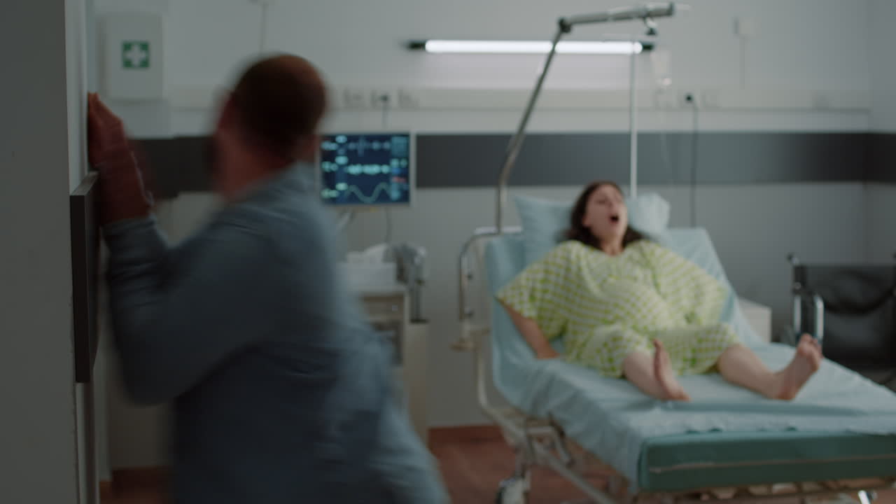 Young man panicking while pregnant wife having contractions