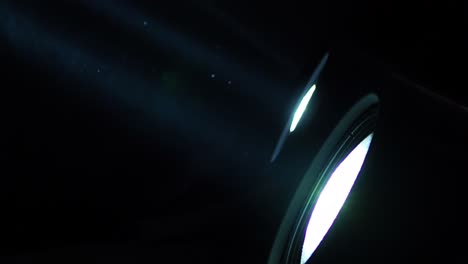 static background shot of dust particles flying through a light beam from a spotlight during showtime, with copy space